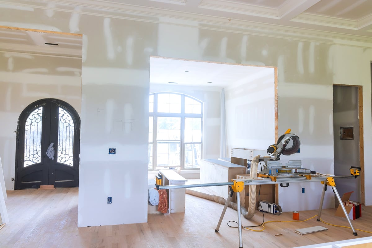 Modern living space during a home renovation, showcasing framing and tools