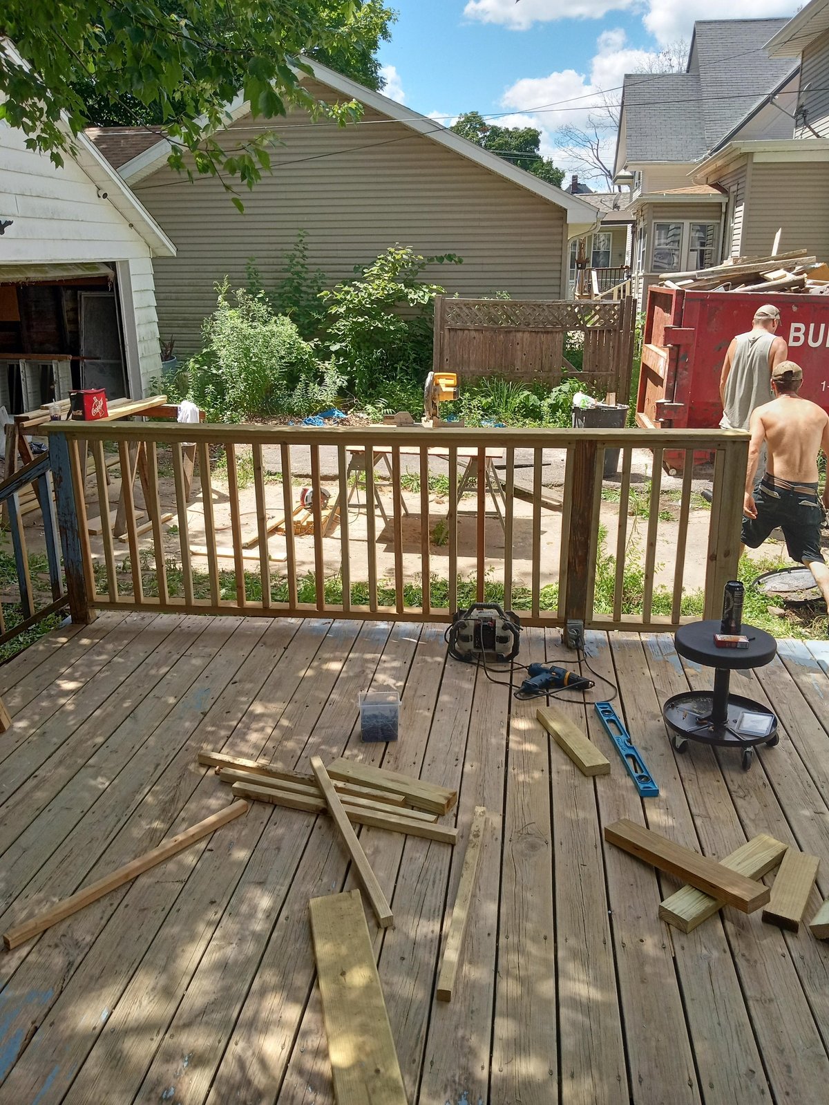 Remodeling crew mid-build installing deck framing and materials