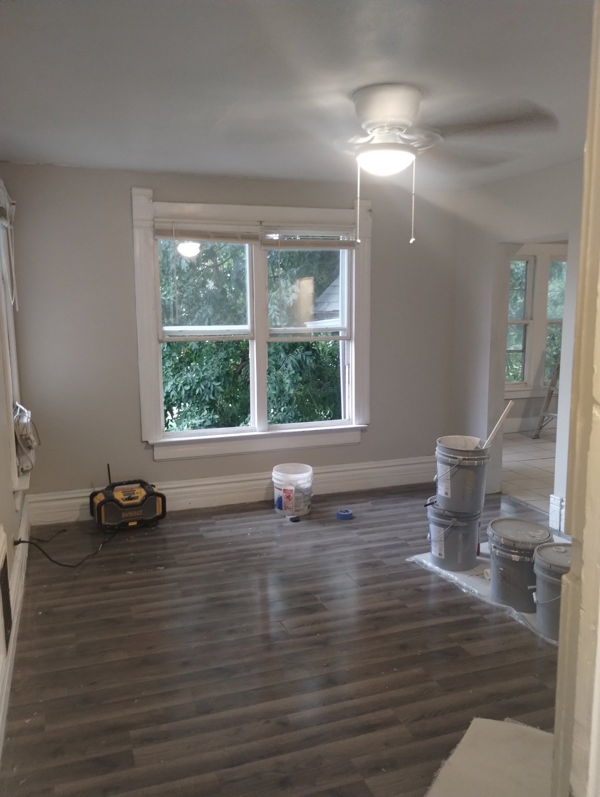 Empty room mid-renovation being assessed before a remodel, with new flooring and daylight